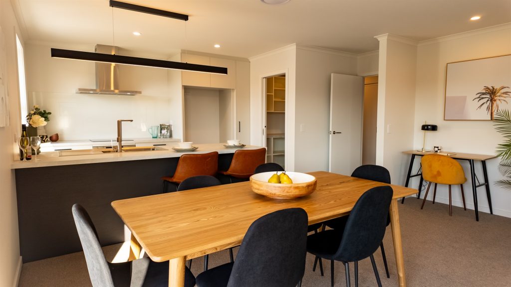 Open Plan living room with dining table in front and kitchen in back